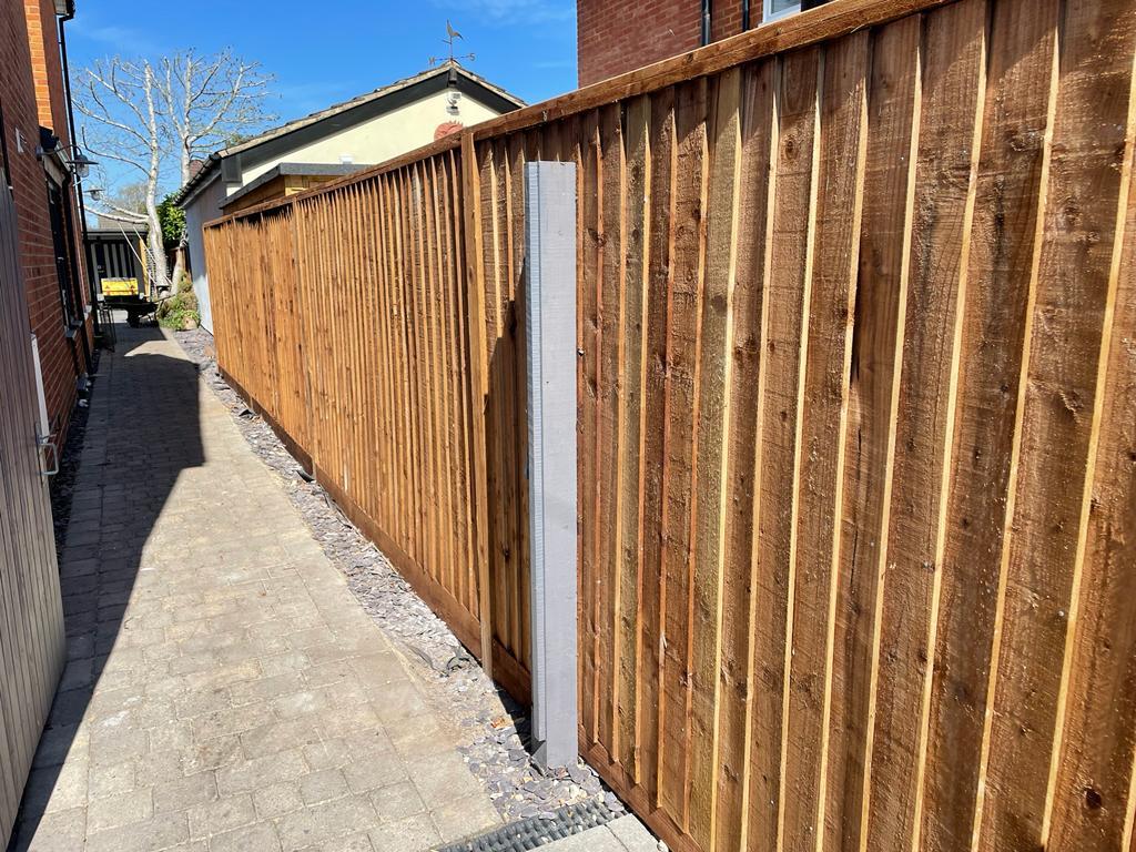 Freshly installed closeboard fence along side passage